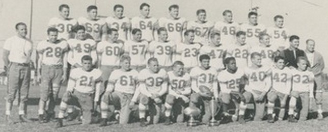 Undefeated Cardinals were coached by Raleigh Holt (stanmding,m left) and led by Eddie Crain (31), Freddie Espy (25), and Frank Smith (40). Assistant coach Bob Breitbard is in dark top , second row.