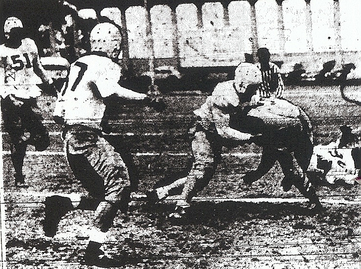 San Diego's Harry west stops Long Beach Wilson's Ray McCoy early in Cavemen's 27-13 playoff loss. Bob Conklin (51) and Cosimo Cutry (37) arrive to support.