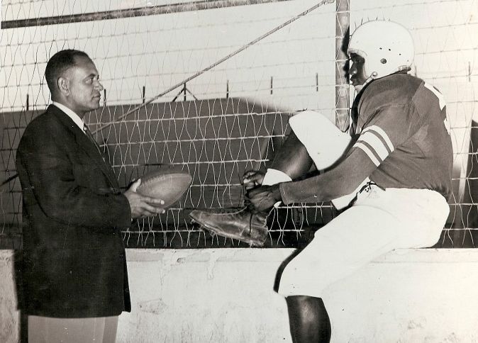 San Diego Police detective Bert Ritchey, star of 1925 and 1926 teams. chats up Charlie Powell, star of 1950 Cavers.