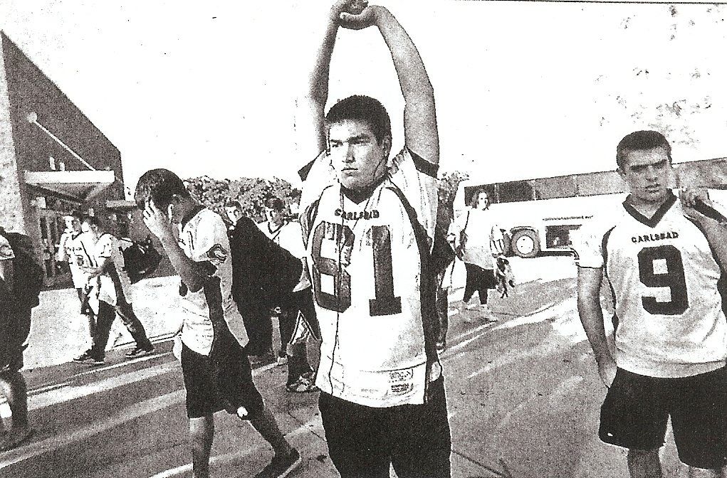 Mode of transportation in background, Carlsbad's Connor Sodano stretches after Lancers arrived at Westview.