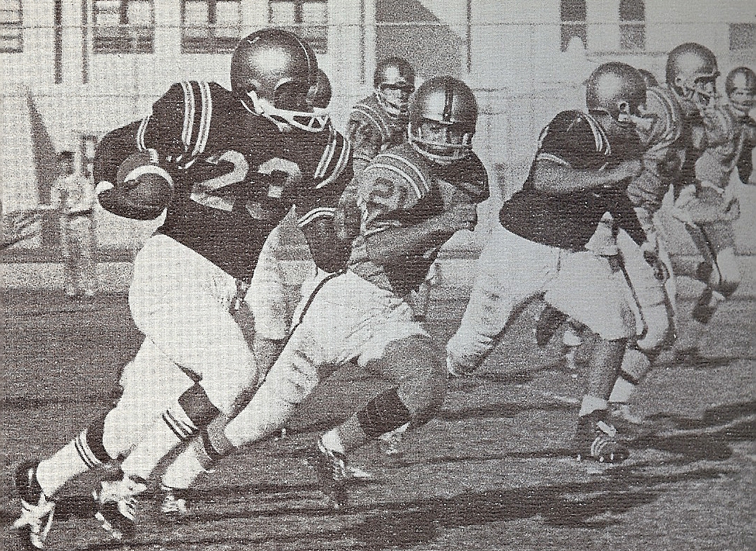 With Cota (right) leading the way, St. Augustine's Henry (Bunny) Daniels outruns Point Loma defense.