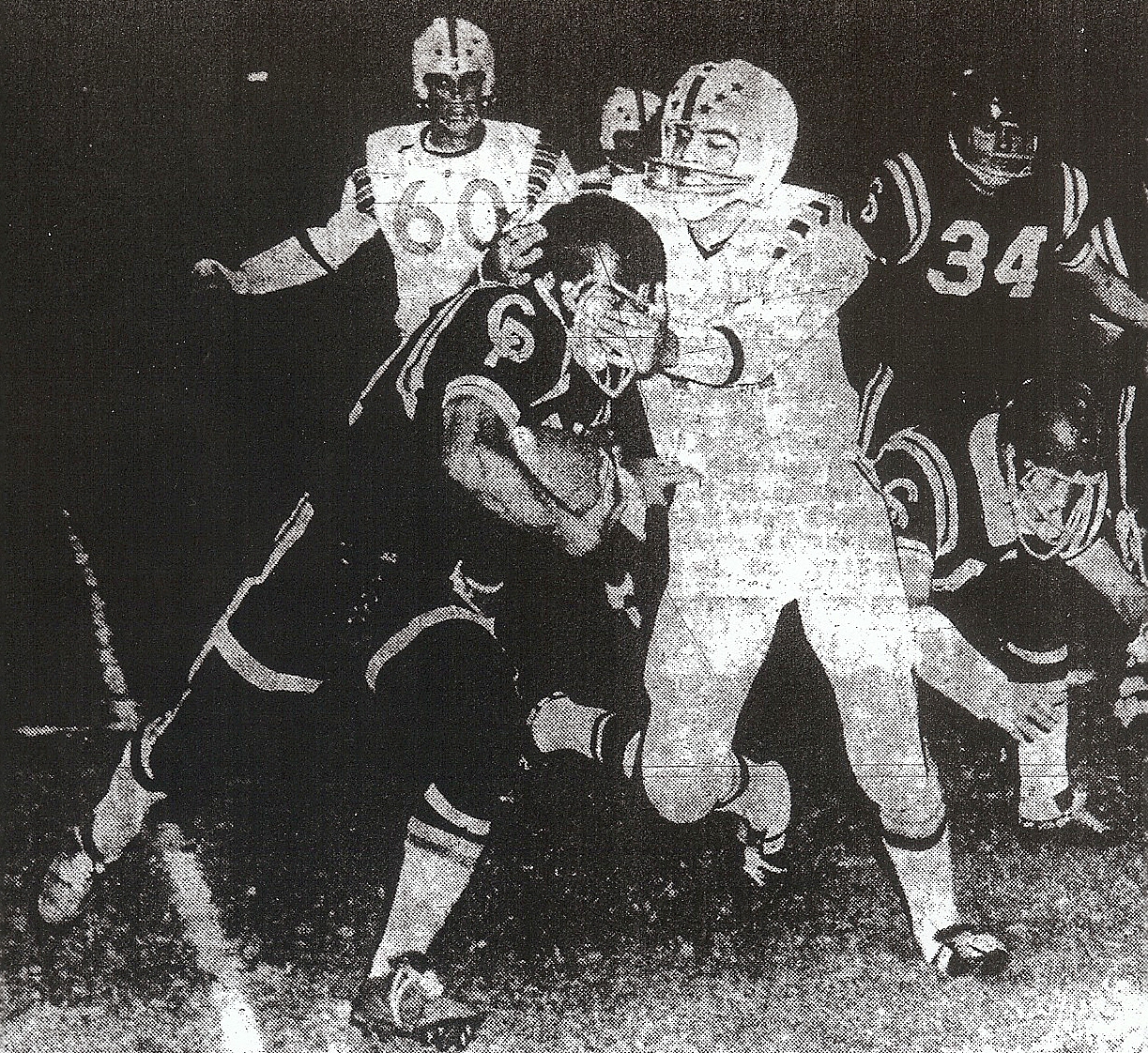 Escondido's Joe Reyes applies facemask technique to bring down Castle Park's Ray Sablan in Cougars' 21-14 victory for County Conference championship.
