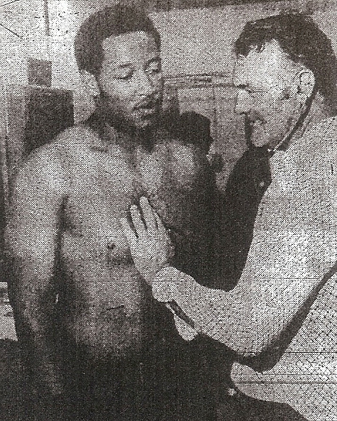 Dr. George Brown, examining future NFL lineman Claudie Minor, who also served as team physician at San Diego State and was leader of push for Granite Hills' Valley stadium.