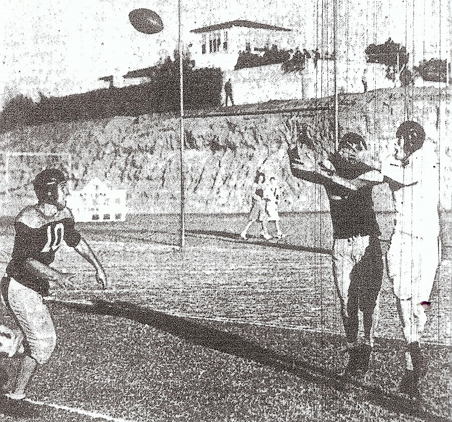 What catches your eye? The pass intercepted by Point Loma against Kearny or the two coeds in background strolling into the game after kickoff. Yoto Takeshita picked the pass from Dick Pedrin to Bob Walke, while Point Loma's Pete Simmons (10) arrived to support Takeshita.